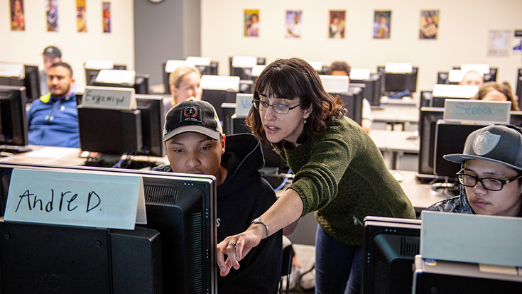 Librarian helping a student in the library classroom