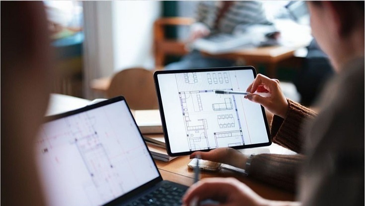 Students using digital technology in a cozy cafe