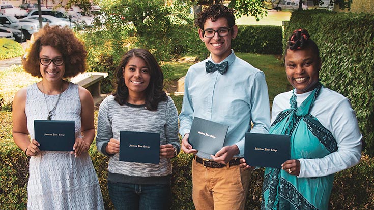 A group of students holding their scholarship awards